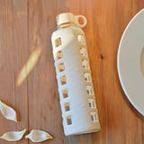 purifyou 40/32/22/12 oz Borosilicate Glass Water Bottles with Volume Markers, Silicone Sleeve, Stainless Steel Lid, Reusable Bottle for Water, Juice, Gym, and Fridge Storage (32oz Pearled Ivory)